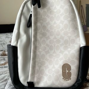 This is a brand new coach book bag in the color cream and white